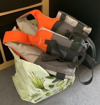 A swimming bag and orange life jacket 